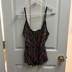 Cute boutique tank. Multi colored with gold shimmer. Black straps. Low cut.